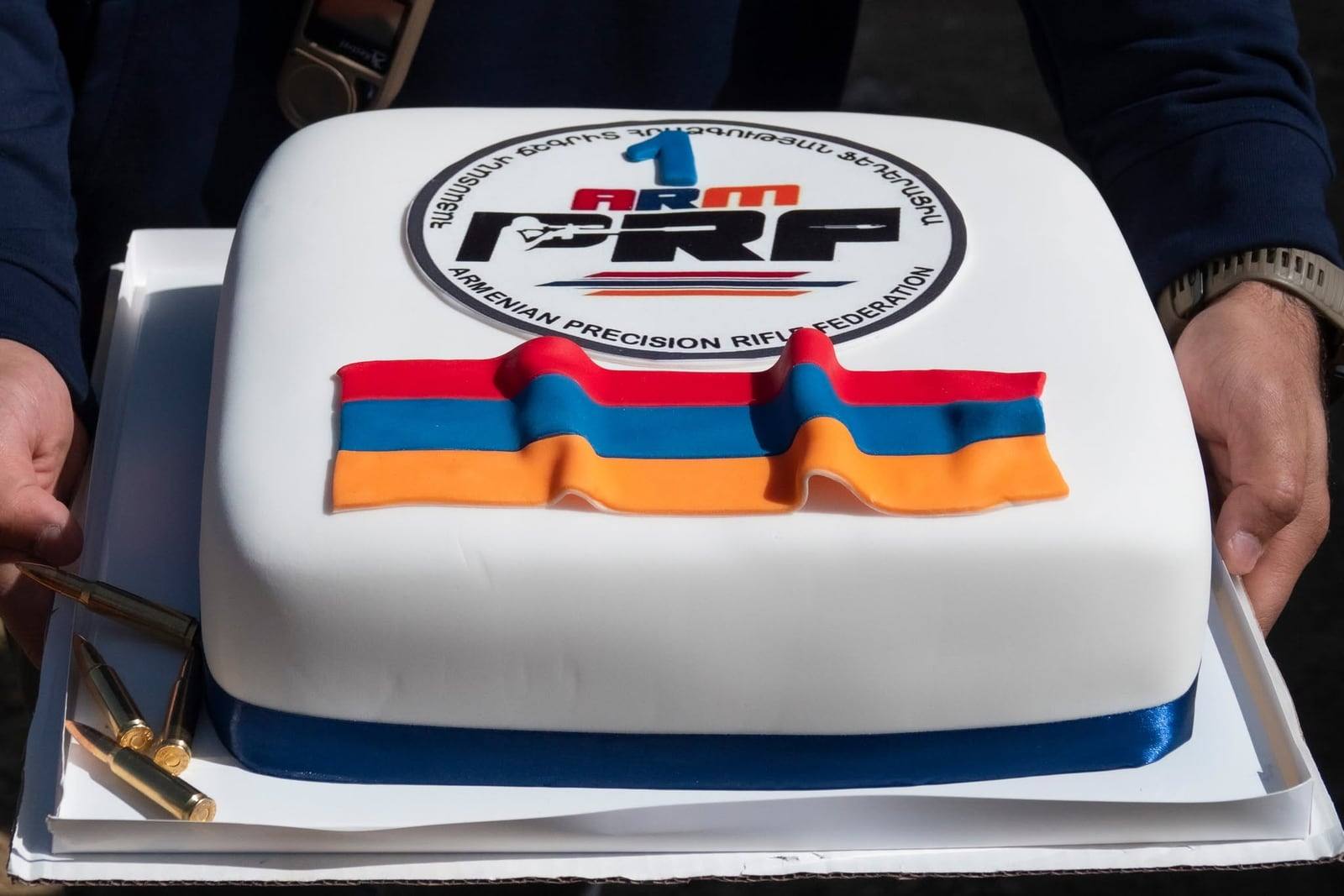 The anniversary cake with the ARMPRF crest, cartridges laid beside it