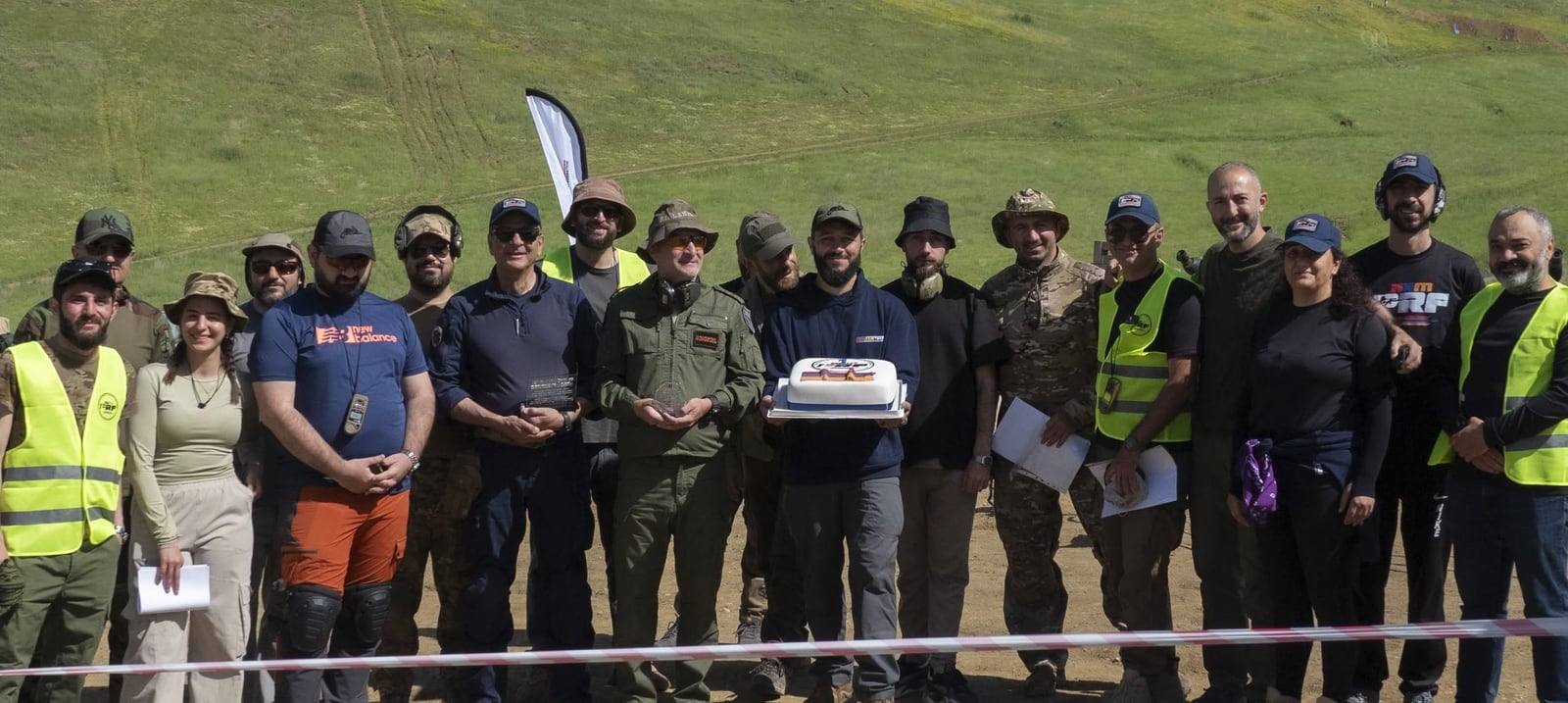 Federation members with the cake, gathered at the range for a group photograph