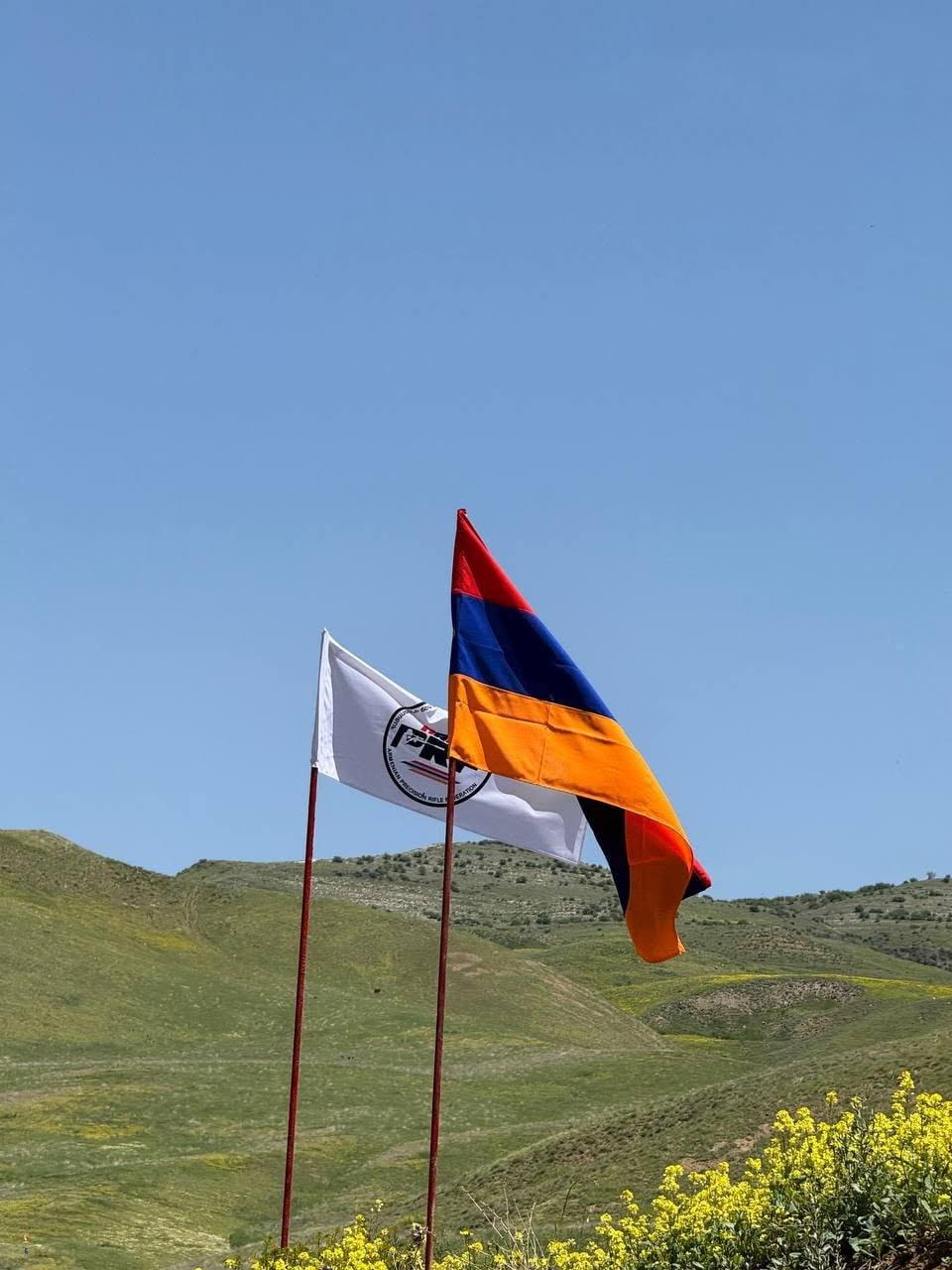 The Armenian and federation flags on the hillside above the range