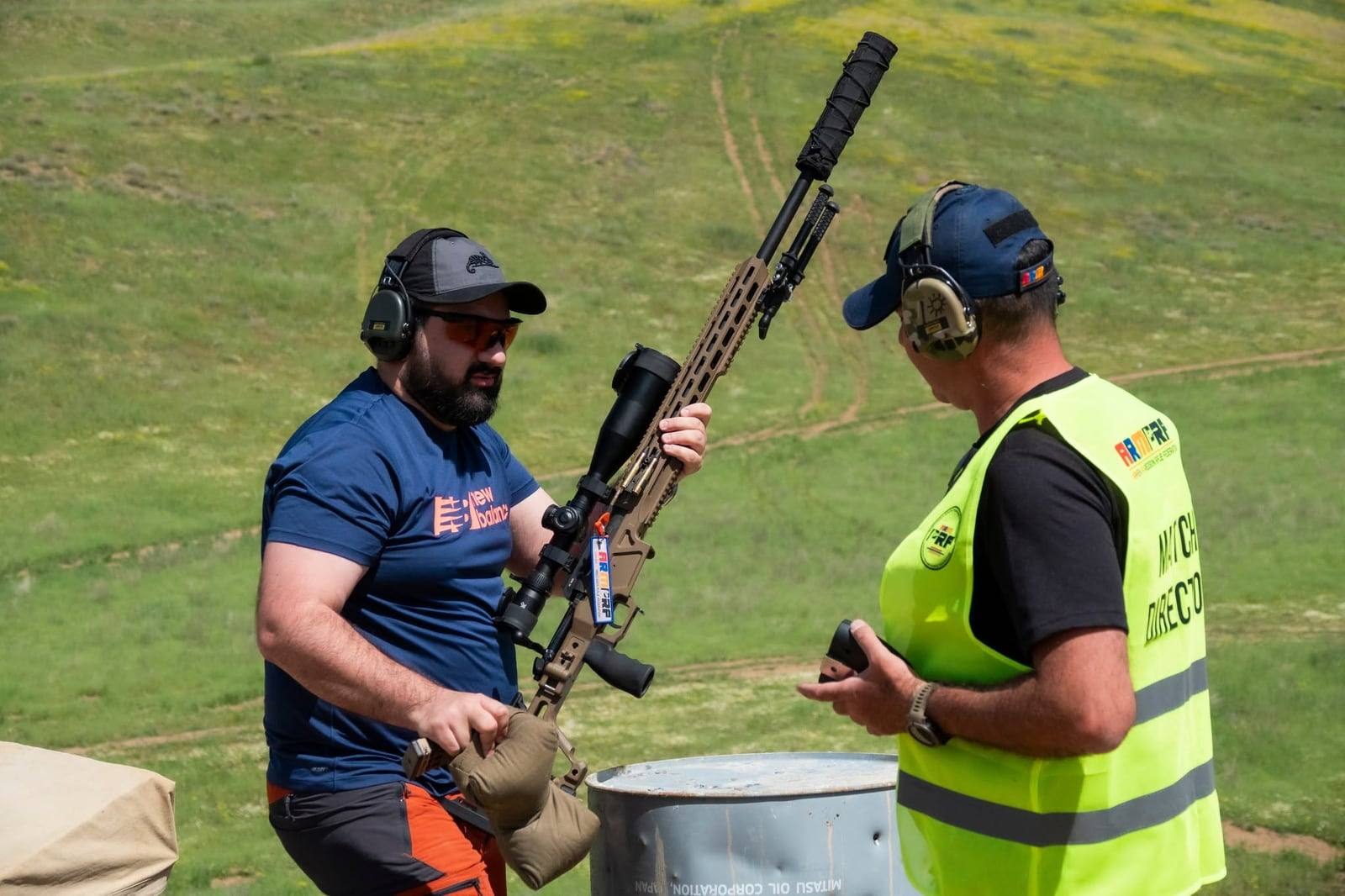 The match director and a competitor during a rifle check