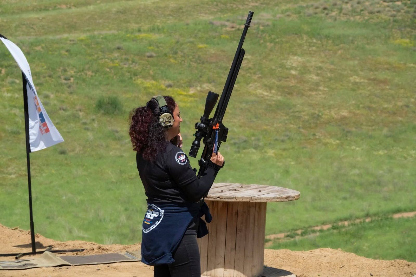 A competitor holding her rifle before a stage