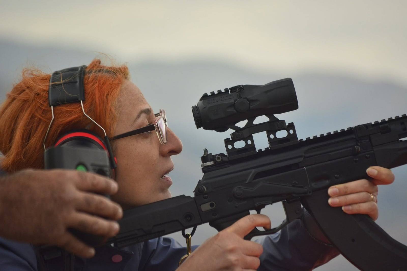 A competitor shooting a self-loading rifle with a magnifier behind the optic