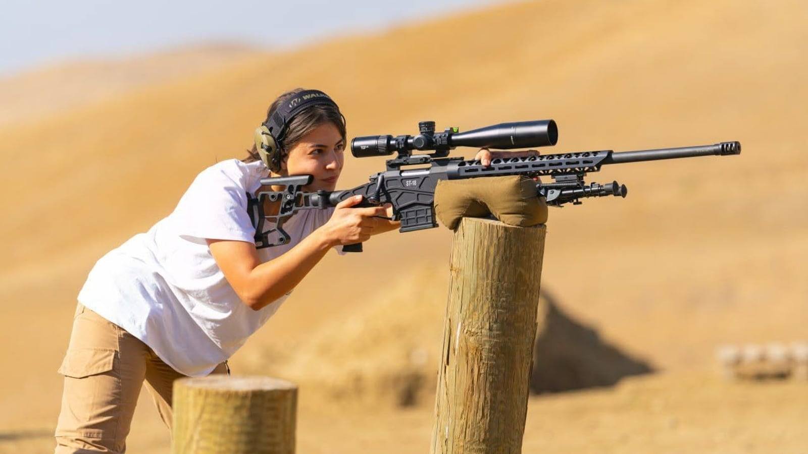Maria Marutyan shooting a Sabatti ST-18 off a wooden post