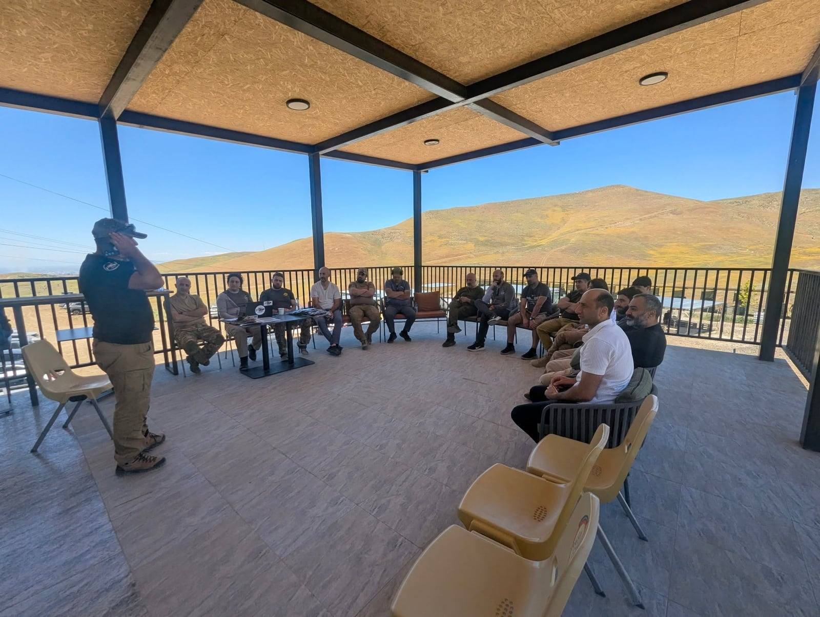The federation's annual meeting under the shelter at the range, hills beyond